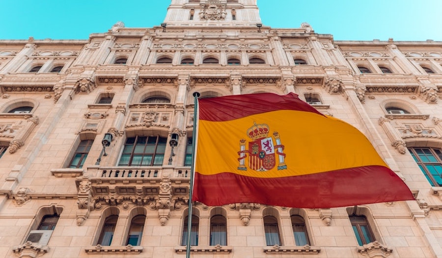 Spanish flag in front of a building near a pr agency